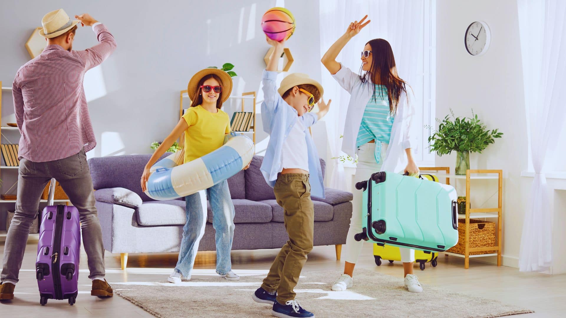 Excited family in vacation hats with suitcases, beach ball, and floatie ready for a fun, budget-friendly getaway.